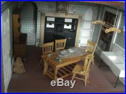 A very large traditional style furnished & decorated wooden dolls house