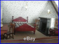 A very large traditional style furnished & decorated wooden dolls house
