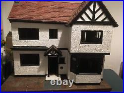 Antique hand made wooden dolls house on base with castors. Solid-Very heavy