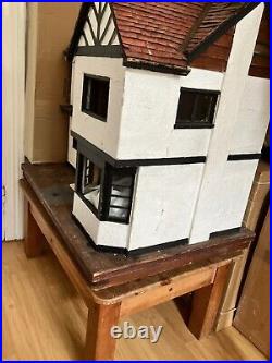 Antique hand made wooden dolls house on base with castors. Solid-Very heavy