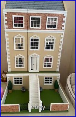 Collectors wooden dolls house with furniture and dolls