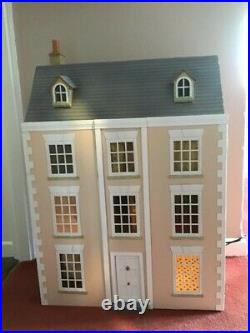 Large wooden dolls house with electric lights and plug sockets