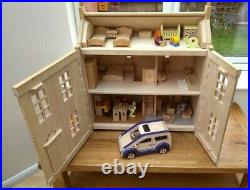 Plan Toys wooden dolls' house with family, furniture and accessories