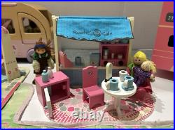 Rosebud Wooden dolls house And Village shops. Full furniture and figures inc Rosebud Wooden dolls house And Village shops. Full furniture and figures inc