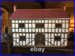 Tudor dolls house. Never been used. Wooden 34in wide x16in deep x 28in high