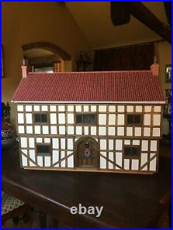 Tudor dolls house. Never been used. Wooden 34in wide x16in deep x 28in high