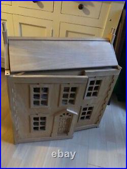 Wooden dolls house with complete furniture set including 10 dolls. Beautiful