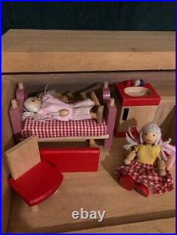 Wooden dolls house with complete furniture set including 10 dolls. Beautiful