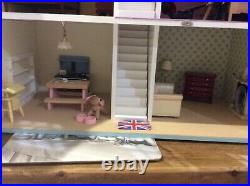 Wooden dolls house with furniture